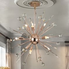 a chandelier hanging from the ceiling in a living room