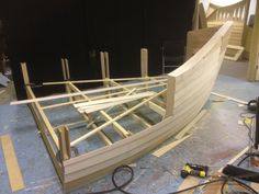 a wooden boat being built in a workshop