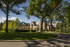 a large house surrounded by trees and grass