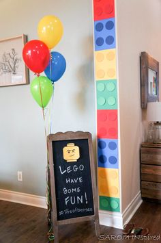 a lego themed party with balloons and a sign