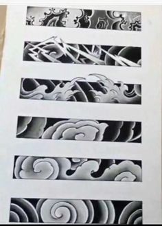 some black and white paper with designs on it's side, including swirls