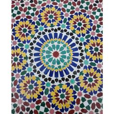 an intricately designed tile with colorful designs on the outside and inside of it's surface