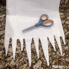 a pair of scissors sitting on top of a white bag