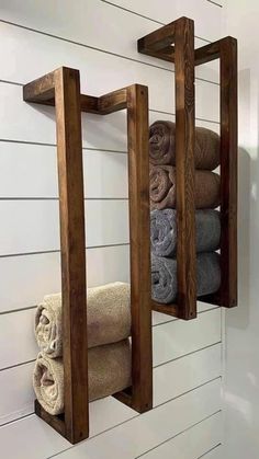 two wooden shelves holding towels and folded towels