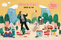 a woman standing in front of a group of toy houses and trees with the words mississippi above her