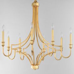 a gold chandelier with six lights hanging from it's center and four arms