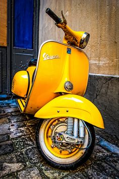 a yellow scooter parked in front of a building