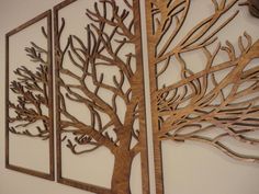 three metal wall art pieces with trees on them