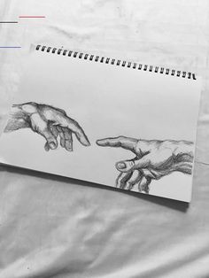 a drawing of two hands reaching out to touch each other's fingers on a sheet of paper