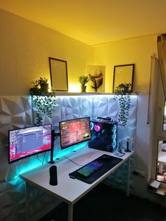 two computer monitors sitting on top of a white desk