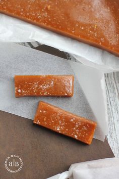 two pieces of food sitting on top of wax paper