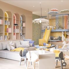 a living room filled with furniture and lots of bookshelves next to a play area