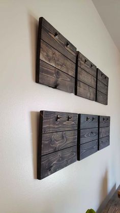 three pieces of wood are hanging on the wall