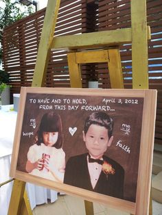 a wooden easel with an image of two children on it