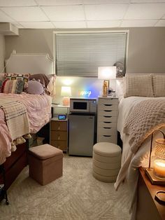 a bedroom with a bed, dresser and other items in the room that is well lit