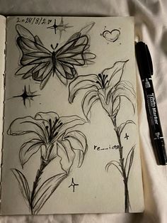 an open notebook with drawings of flowers and butterflies