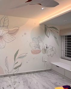 a bathroom with flowers painted on the wall