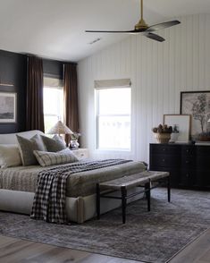 a bedroom with a bed, dresser and window in it's centerpieces