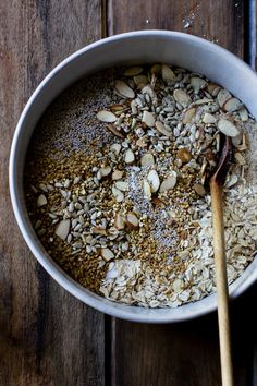 a bowl filled with oatmeal and nuts on top of a wooden table