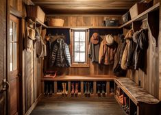 a wooden closet with several coats and boots hanging on the wall