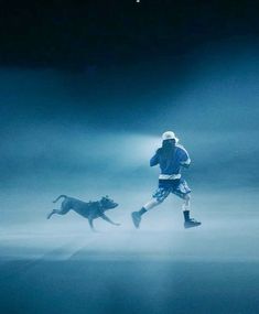 a man running with his dog in the dark