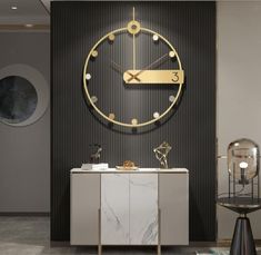 a large clock mounted to the side of a wall next to a table and chair