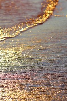 the beach is covered in golden sand and water