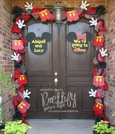 the front door to mickey mouse's house is decorated with red and black decorations