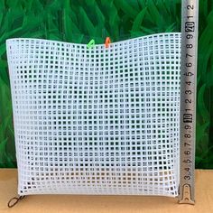 a white plastic bag with a ruler on it