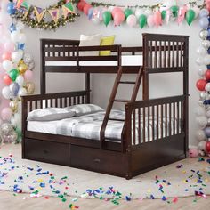 a bunk bed with two sets of drawers underneath it and balloons in the back ground