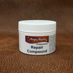 a jar of repair compound sits on a brown surface