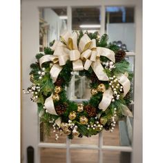 a christmas wreath hanging on the front door