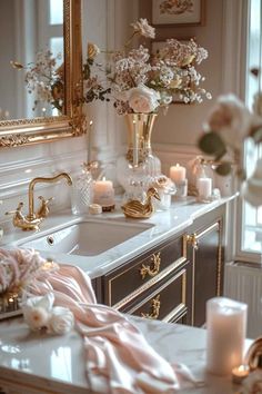 a bathroom sink with candles and flowers on it