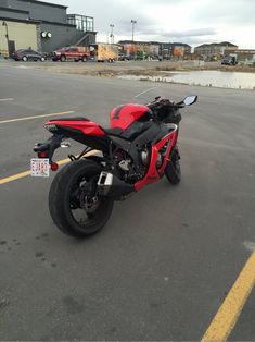 a red motorcycle parked in a parking lot