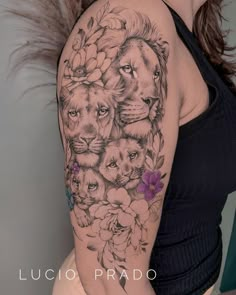 a woman's arm with an image of lions and flowers on it