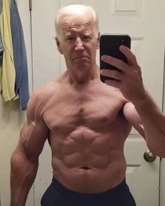 an older man taking a selfie in front of a mirror with his cell phone