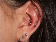 a woman with three piercings on her ear