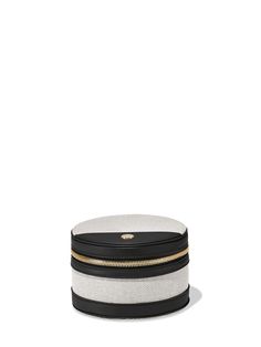 a black and white hat with gold zippers