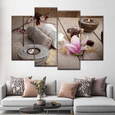 a living room with a couch and paintings on the wall, including flowers in vases