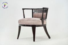 a wooden chair with a beige upholstered seat and beaded armrests