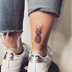 a person with a pineapple tattoo on their leg