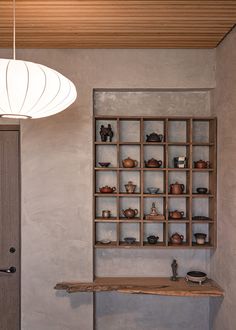 a room with a table and shelves on the wall