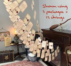 a room with many pieces of paper hanging from the ceiling and writing on the wall