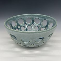 a glass bowl with holes in the middle