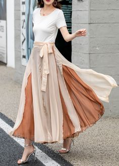 "Introducing our khaki double-layered chiffon wrap skirt. This versatile piece is perfect for adding a touch of elegance to your wardrobe. The lightweight chiffon fabric drapes beautifully, while the double-layered design adds dimension and movement. The wrap style allows for an adjustable fit. Whether you're dressing it up for a special occasion or keeping it casual with a simple top, this skirt is a must-have.  DETAILS: * Chiffon skirt * Chiffon lining * Wrap skirt * with long belt * High waistband * Circle Skirt * Perfect for spring, summer and autumn * Machine Washable in Warm/Cold Water; Do not bleach / Mid-iron / Hang Dry * Great for Daily Wear/Wedding/Bridesmaid Dresses/Vacation/Date Night/Graduation Ceremony/Party etc * The model is 170 cm (5' 7\") tall with 85 cm(33.4\") bust and Double Layered Skirt, Skirt Movement, Layering Skirts, Long Layered Skirt, Skirt And Top Outfits, Chiffon Wrap Skirt, Flowy Long Skirt, Warm Skirt, Pleated Circle Skirt