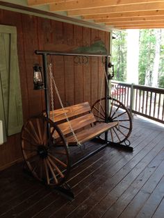 a wooden porch with a swing chair on it