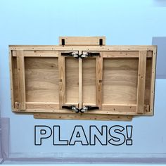 a wooden cabinet with two doors and the word plans above it that says plans on blue background