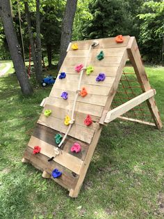 an outdoor climbing wall made out of wooden boards