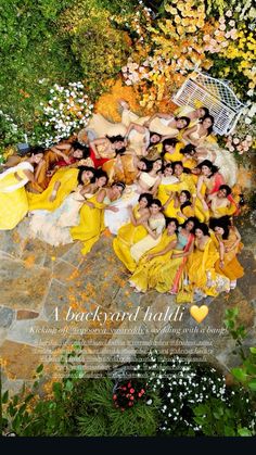 a group of people laying on top of a stone floor next to trees and flowers