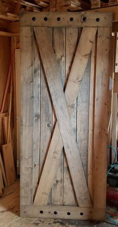 a large wooden door sitting inside of a building